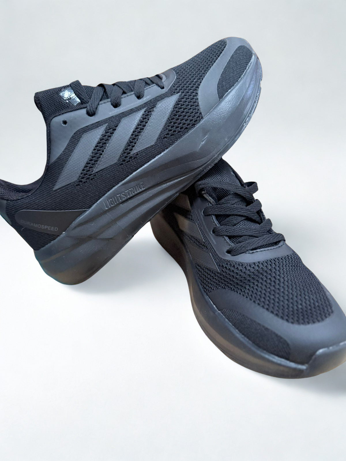 Pair of black athletic shoes on a light gray background