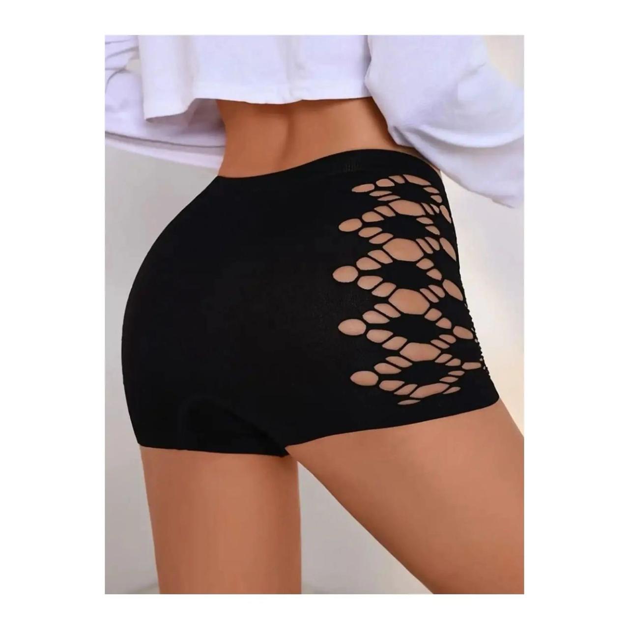 Black shorts with cut-out design on a plain background